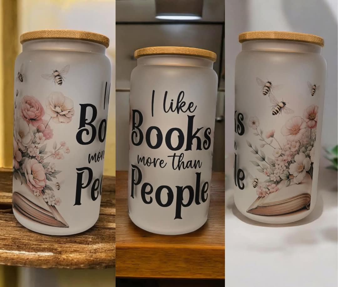 I Like Books More Than People 16oz frosted glass cup with bamboo lid and a straw.